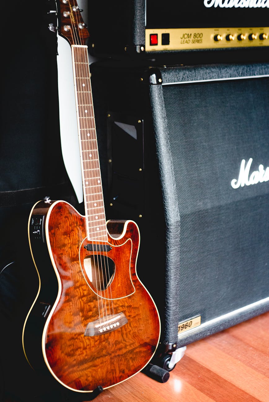 acoustic guitar next to marshall amplifier